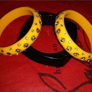 2 Yellow Lucite Yellow bangles and a black bangle